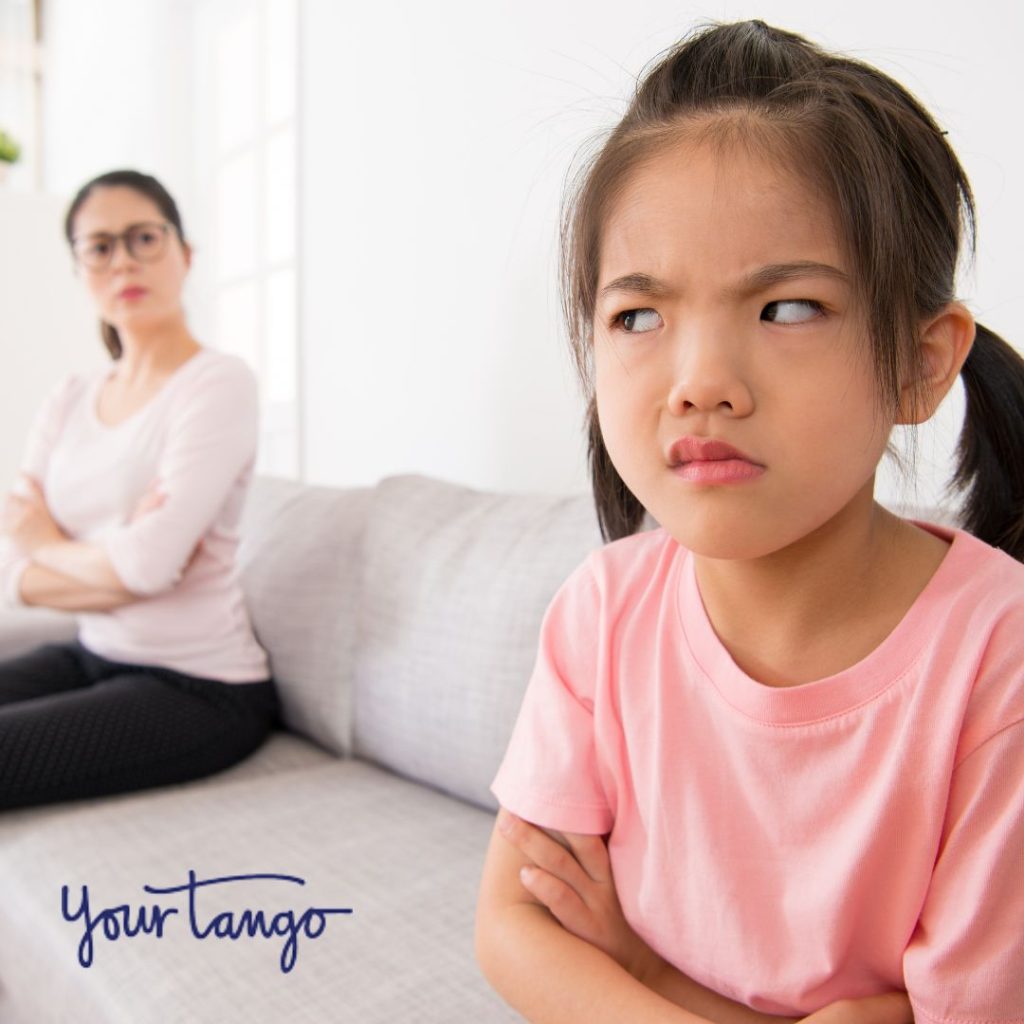 Little girl angry with her mother sitting on couch IG